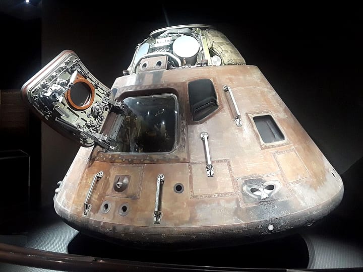 An Apollo command module on display with its hatch open