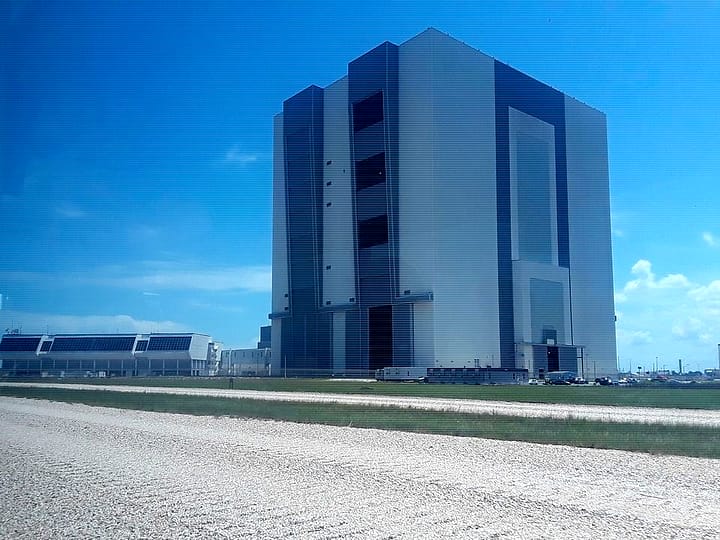 The Vehicle Assembly Building from across a gravel crawlerway