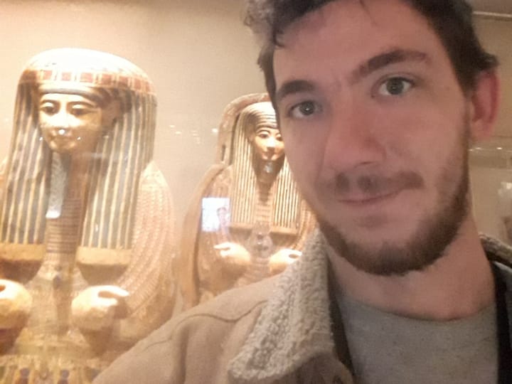 A selfie in front of two painted Egyptian coffins at the Met