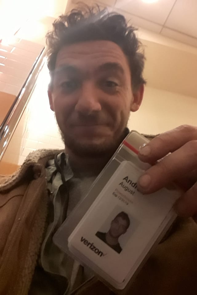 Andy holding up his Verizon contractor badge